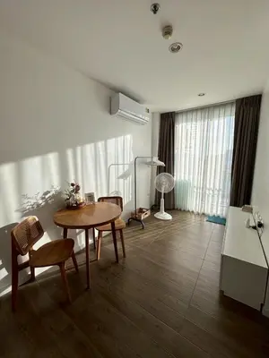 a living room with a table and chairs at Free Wi-Fi Private Room I Near the Mall Bangkapi in Bangkok