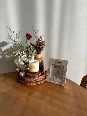 a table with a candle and flowers in a vase at Free Wi-Fi Private Room I Near the Mall Bangkapi in Bangkok
