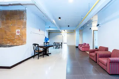 a lobby with chairs and a table in a building at The Hidden Khaosan Bangkok in Bang Bua Thong Railway Station