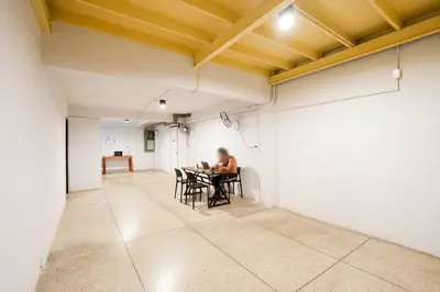 a person sitting at a table in an empty room at XX Mitr Khaosan Bangkok in Bangkok