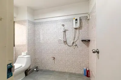 a bathroom with a shower and a toilet in it at Cozy 5-story house, 2 mins walk BTS, BKK in Bangkok