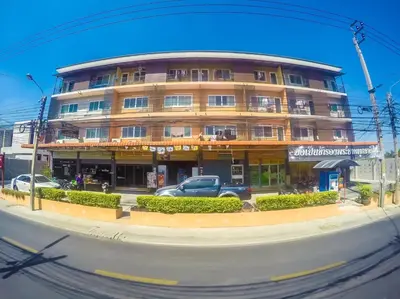 a building with a car parked in front of it at Nuanchan Apartment in Ban O Pao