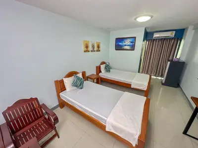 a hospital room with two beds and a television at Nuanchan Apartment in Ban O Pao