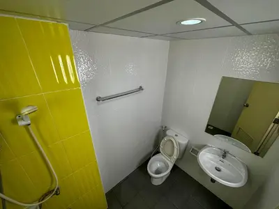 a bathroom with a sink and a toilet and a mirror at Nuanchan Apartment in Ban O Pao