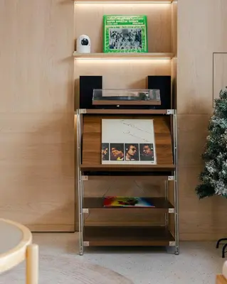 a shelf in a room with a christmas tree at Bembis Hotel Charoenakorn 10 in Chinatown