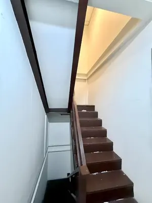 a staircase in a building with a glass floor at xx zNAP - Khaosan Bangkok แนป ข้าวสาร กลางตรอกข้าวสาร in Bang Bua Thong Railway Station