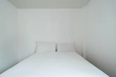 a white bed in a white room at SleepPop Sukhumvit 42 - BTS Ekkamai in Phra Khanong