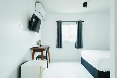 a hotel room with a bed and a desk at SleepPop Sukhumvit 42 - BTS Ekkamai in Phra Khanong