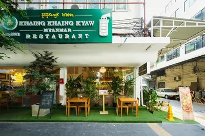 a restaurant with tables and chairs in front of a building at SleepPop Sukhumvit 42 - BTS Ekkamai in Phra Khanong