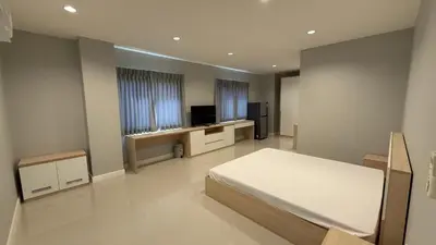 a bedroom with a bed and a television in it at Nene Apartment in Ban Bang Talat
