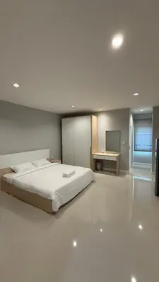a bedroom with a bed and a desk and a television at Nene Apartment in Ban Bang Talat