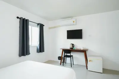 a bedroom with a bed and a desk and a television at XX SleepPOP Sukhumvit 42 - BTS Ekkamai Station - Bangkok in Phra Khanong