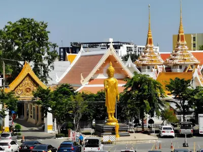 a large gold statue in front of a building at XX SleepPOP Sukhumvit 42 - BTS Ekkamai Station - Bangkok in Phra Khanong