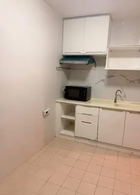 a kitchen with white cabinets and a microwave at อุดมสุข BTS udomsuk in Bangna