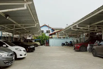 a group of cars parked in a parking lot at Sabai room in Taling Chan