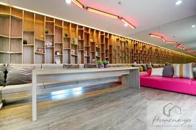 a lobby with a couch and a table and shelves at Plum condo Bang-yai station in Nonthaburi