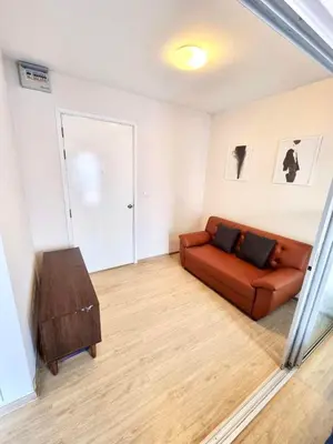 a living room with a couch and a table at Plum condo Bang-yai station in Nonthaburi