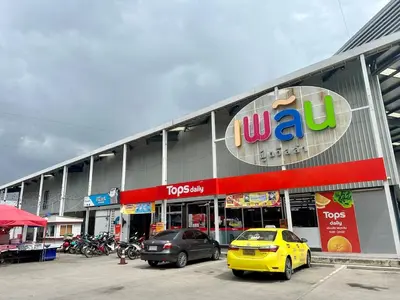 a yellow car parked in front of a store at Plum condo Bang-yai station in Nonthaburi