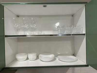 a shelf with plates and wine glasses on it at New Apt, Near Siam Paragon, 2 Min to BTS 1BR,4Pax in Bangkok