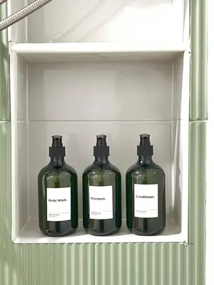 three bottles of wine sitting on a shelf in a refrigerator at New Apt, Near Siam Paragon, 2 Min to BTS 1BR,4Pax in Bangkok