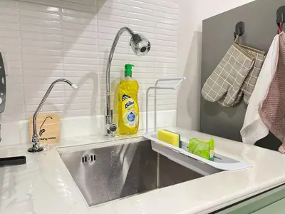 a kitchen sink with a bottle of detergent on it at New Apt, Near Siam Paragon, 2 Min to BTS 1BR,4Pax in Bangkok