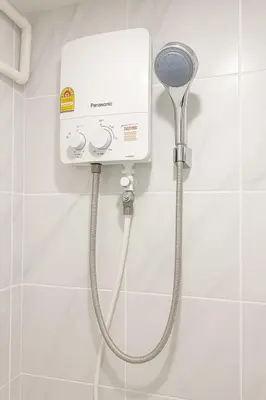 a shower in a bathroom with a shower head at Hug14 Hotel in Ban Bang Toei (1)