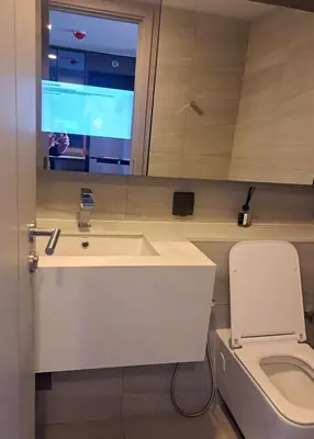 a bathroom with a white sink and a toilet at Luxury duplex condominium Samyan area 28th fl near MRT in Bangkok
