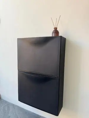 a black refrigerator with a vase on top of it at Scandi Haus near ChinaTown in Bangkok