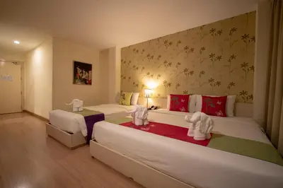 a bedroom with two beds with white elephants on them at Taradii Boutique in Bangkok