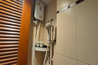 a room with a refrigerator and a hair dryer at Pratunam Family House in Ban Nong Chaeng
