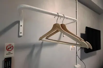 a wooden hanger hanging on a wall at Pratunam Family House in Ban Nong Chaeng