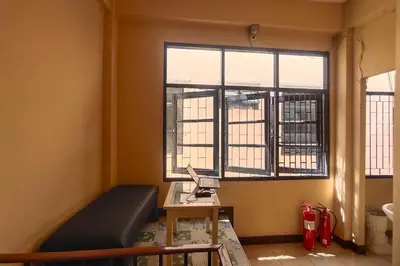 a room with a bed and a desk and a window at Pratunam Family House in Ban Nong Chaeng