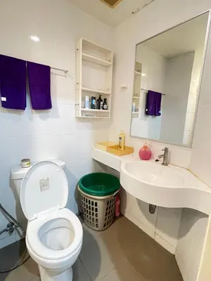 a bathroom with a toilet and a sink and a mirror at Lumpini nawamin in Ban Bang Toei (1)