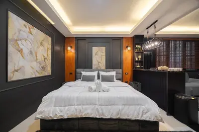 a bedroom with a large white bed in it at Delta 9 Phrakanong in Bangkok