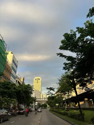 a city street with people riding motorcycles on the road at Super BIG Mid Century Home near River & IconSiam in Khlong San