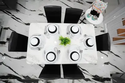 a table with black chairs and a white table cloth at Number 31 Bangkok Family in Bangkok