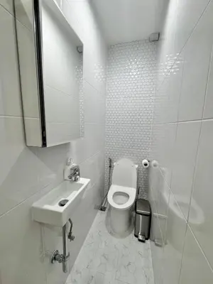 a white bathroom with a toilet and a sink at Number 31 Bangkok Family in Bangkok
