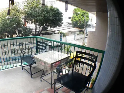 a balcony with a table and chairs on a balcony at Sathitsit Mansion in Bangkok