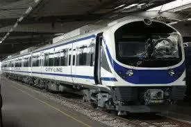a blue and white train on the tracks at a station at Sathitsit Mansion in Bangkok