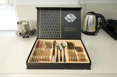 a box of utensils sitting on top of a counter at OH Suites 72 in Bangkok
