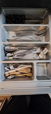 a drawer full of silver utensils in a refrigerator at Stylish New Condo in NANA in Bang Kapi