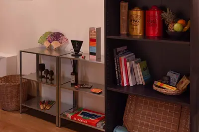 a book shelf filled with lots of books at Walk2BTS, KingBed, FastWiFi, FreeLaundry, Netflix in Khlong Toei
