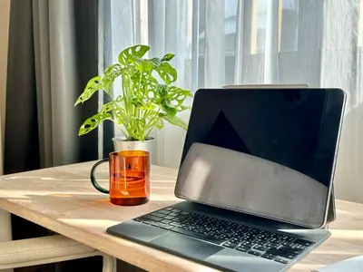 a laptop computer sitting on a wooden table at Walk2BTS, KingBed, FastWiFi, FreeLaundry, Netflix in Khlong Toei