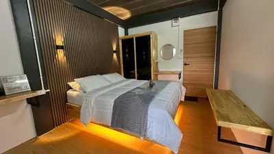 a bedroom with a bed and a wooden floor at Villa Moon Terrace in Bang Khen