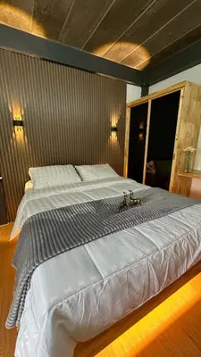a large white bed in a bedroom with lights at Villa Moon Terrace in Bang Khen