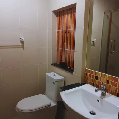 a bathroom with a toilet and a sink at Leon Sukhumvit 62 in Bangkok