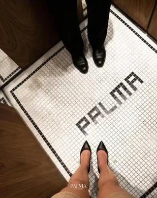 a person wearing black shoes on a tiled floor at Palma Hotel in Bangkok