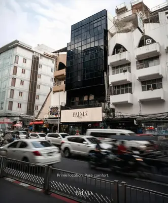 a busy city street with cars and buildings at Palma Hotel in Bangkok