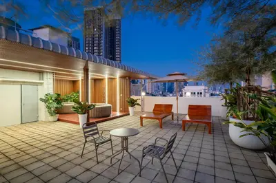 a patio with chairs and tables on a building at Capitel Sathorn in Yan Nawa