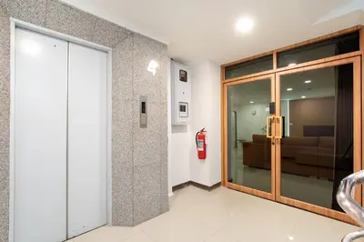 a lobby with a sliding glass door with a fire hydrant at Capitel Sathorn in Yan Nawa